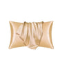 A luxurious satin pillowcase in a champagne gold color, folded and draped.