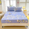 A light blue floral print fitted bed sheet with matching pillows displayed on a bed.