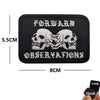 Black embroidered patch featuring two skulls and the text FORWARD OBSERVATIONS with a hook and loop backing