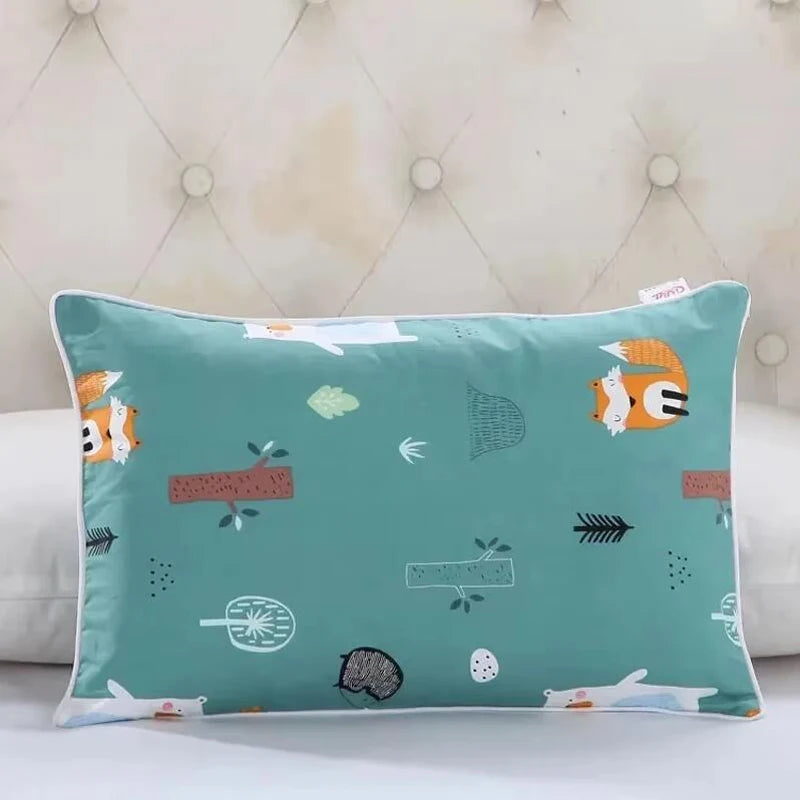 A teal cartoon style children's pillow featuring various animal and nature motifs.