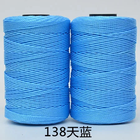 Two spools of bright blue hand knitting and crochet cord for crafting