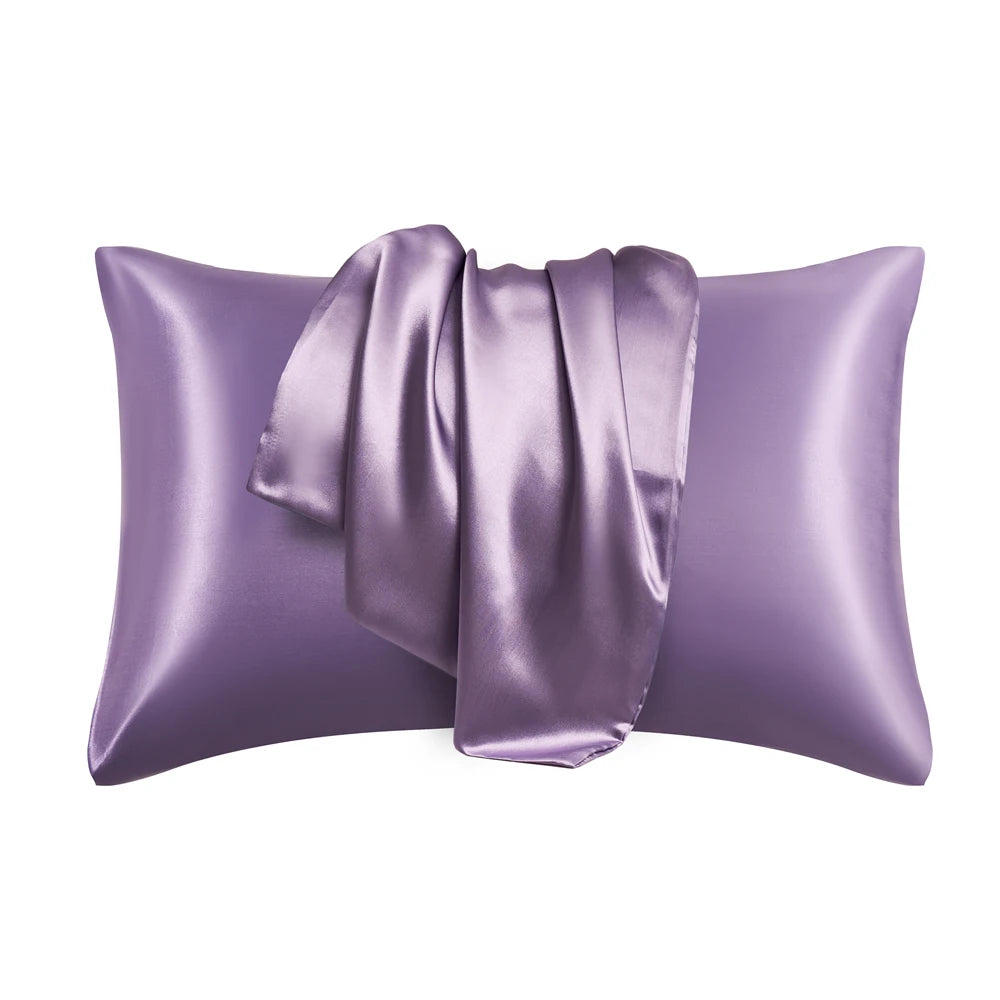 A purple satin silk pillow cover with a gathered fabric detail.