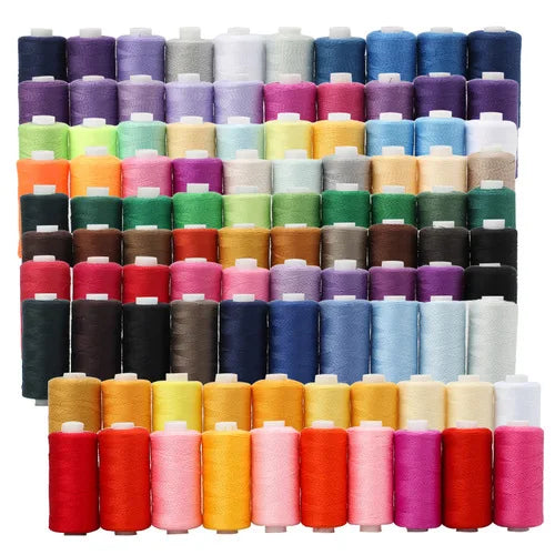A collection of multi-color sewing thread spools in various shades and sizes.