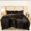 A black faux fur duvet cover set displayed on a bed with light beige upholstered headboards.