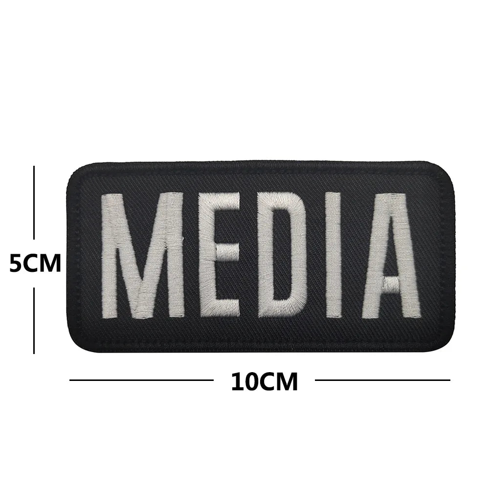 Black embroidered media patch with white text MEDIA and hook and loop backing