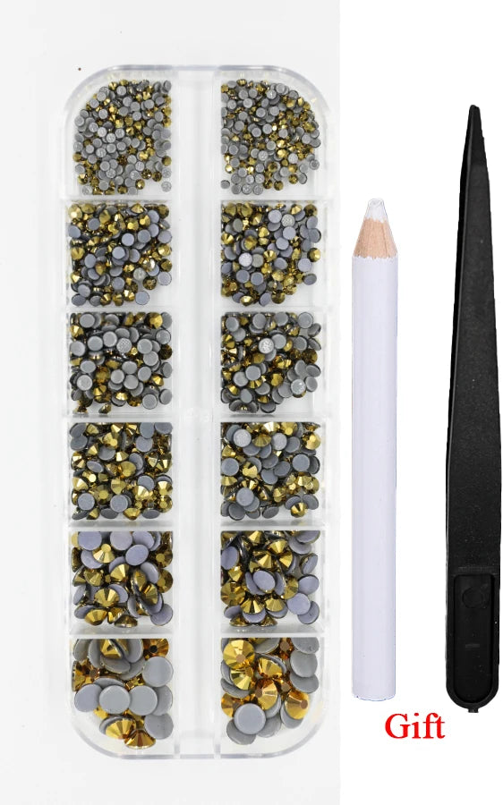 A clear plastic container holds various colored crystal hot fix rhinestones and an applicator tool for crafting.