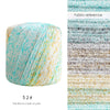 A ball of hand knitting yarn showing a gradient of pearl and rainbow colors with various textures.