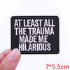 Black embroidered patch with white text that reads At least all the trauma made me hilarious