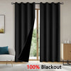 Solid black blackout curtains hanging in a doorway, ready for use.