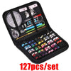 A black mini sewing kit set containing various hand sewing tools and needles.