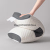 A beige ergonomic neck support pillow with gray accents being held by a hand.