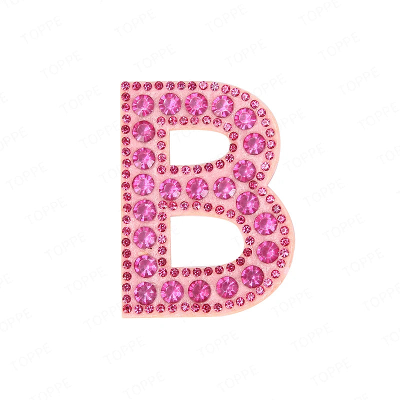 A pink rhinestone letter B patch with a glittery finish.