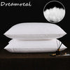 A stack of white sleeping pillows with a close-up of fluffy white down above them.