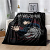 A black throw blanket featuring artwork of a dark-haired character in a blue outfit and a wolf head design.