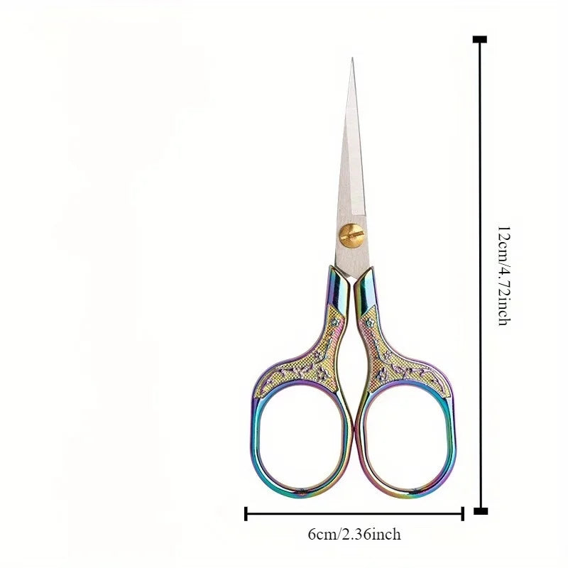 A pair of vintage stainless steel sewing scissors with decorative handles and a pointed blade.