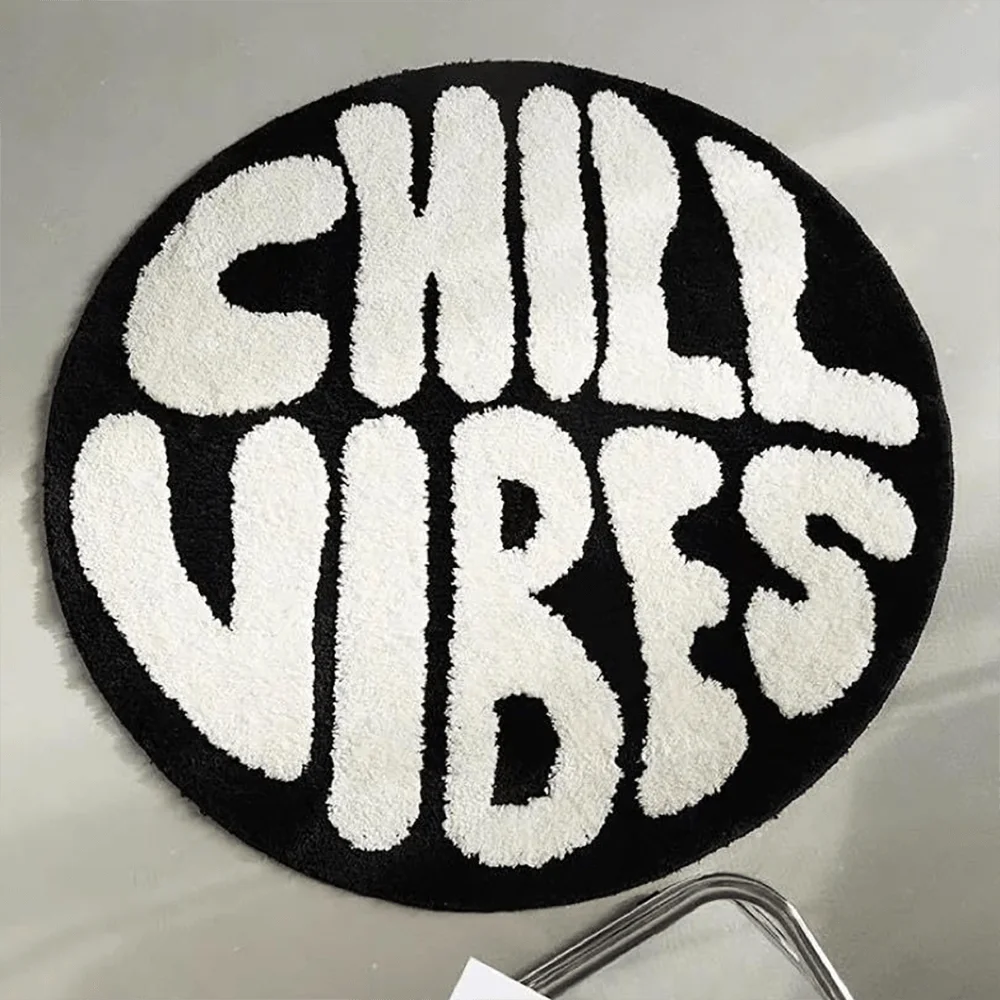 Black round rug with white text reading CHILL VIBES