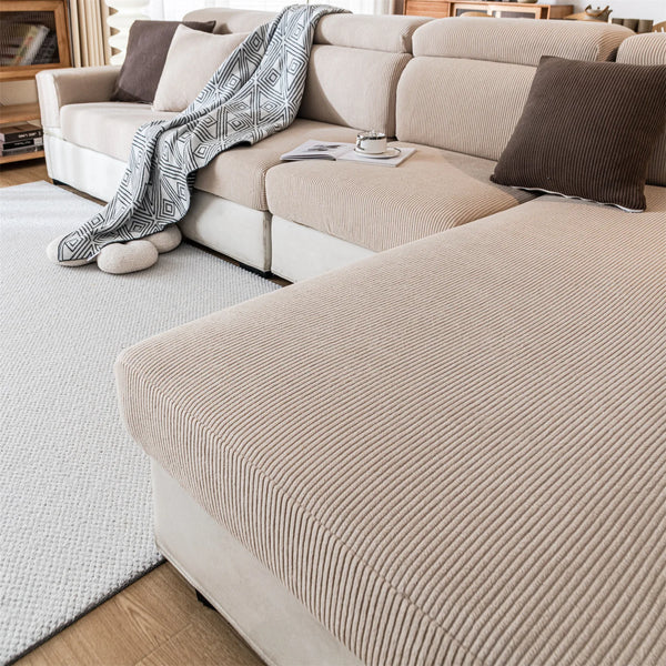 A beige removable jacquard seat cushion cover displayed on a light sofa with neutral pillows and a white rug.