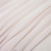 Soft pink luxury bamboo flat sheets draped in flowing fabric