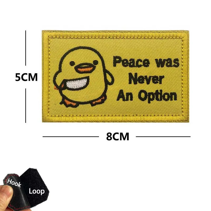 Yellow embroidered patch featuring a smiling yellow duck and the text Peace was Never An Option