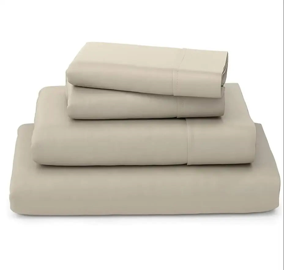 A stack of light beige luxury bamboo bedding sets folded neatly.