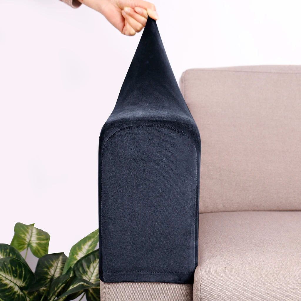 Dark navy velvet sofa armrest covers being held by a hand