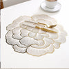 Gold plated peony coasters with delicate line art design on a white surface.