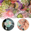 A close-up of various colorful resin flower bead caps and components for jewelry making.