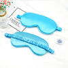 Two light blue silk sleep masks with ruffled edges are displayed on a white background.