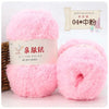 Pink soft coral velvet yarn skeins for crafting with a wooden stick and packaging label