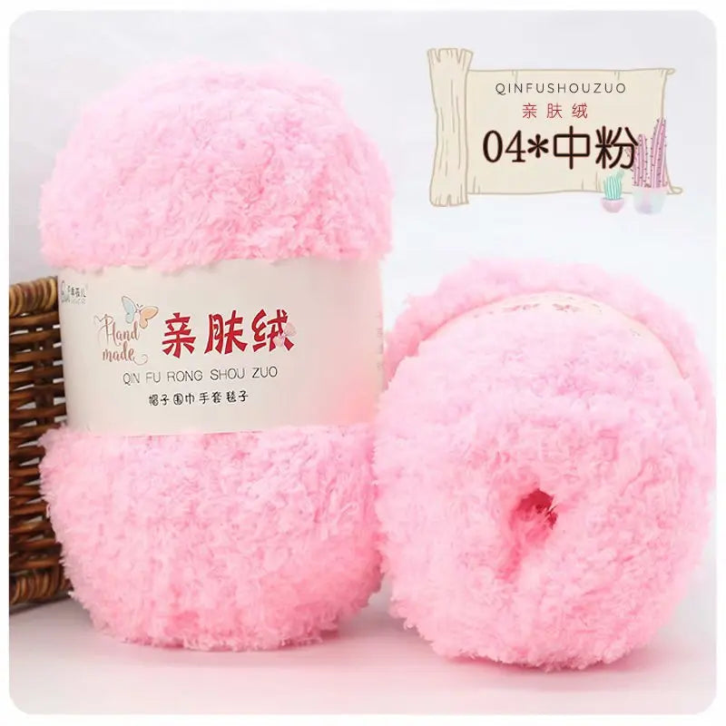 Pink soft coral velvet yarn skeins for crafting with a wooden stick and packaging label