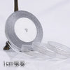 Roll of silver glitter organza ribbon measuring 1cm wide for gift wrapping and crafts
