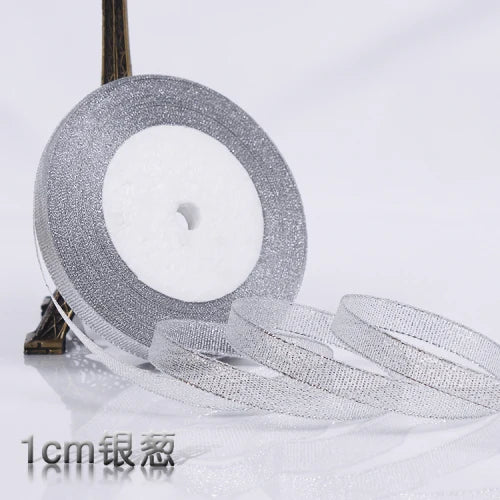 Roll of silver glitter organza ribbon measuring 1cm wide for gift wrapping and crafts