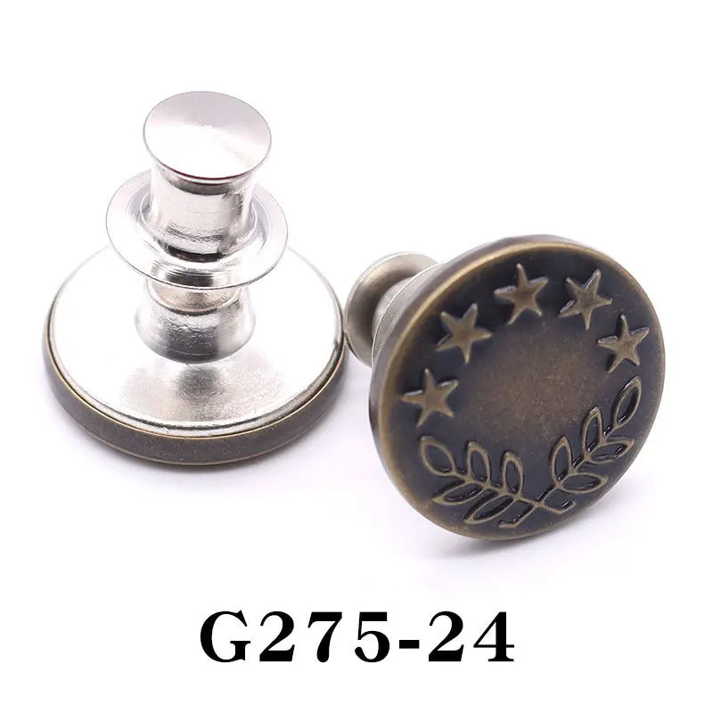 A round, antique brass button pin with a decorative pattern of stars and leaves.