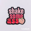 Black embroidery patch with pink and red text that reads Shake some ass