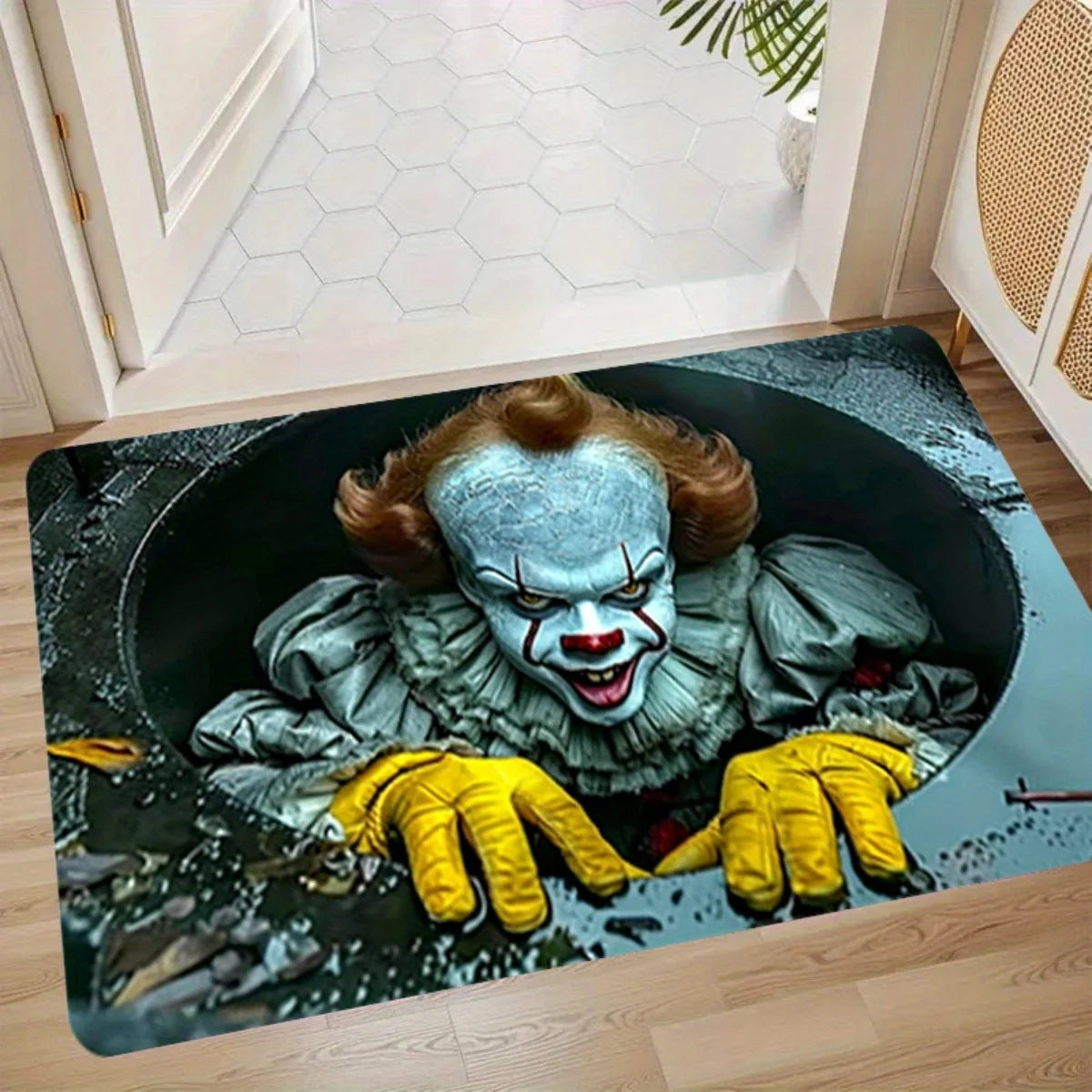 A dark mat featuring a stylized illustration of the Joker character with gray skin and yellow gloves.