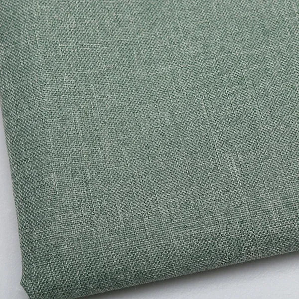 Close-up of coarse green linen and cotton fabric texture.