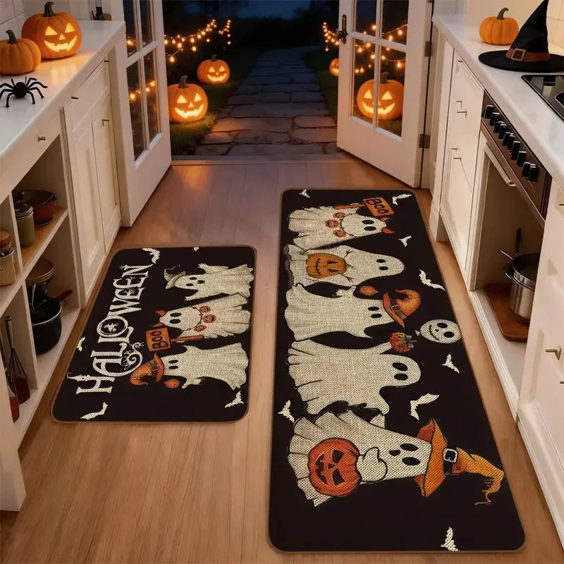 A set of black non-slip kitchen rugs featuring Halloween ghost and pumpkin prints placed on a wooden floor.