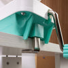 A close-up view of a white and teal hand-operated wool yarn winder mechanism.