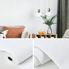A close-up of white self-adhesive 3D thermal insulation wallpaper with a linen texture.