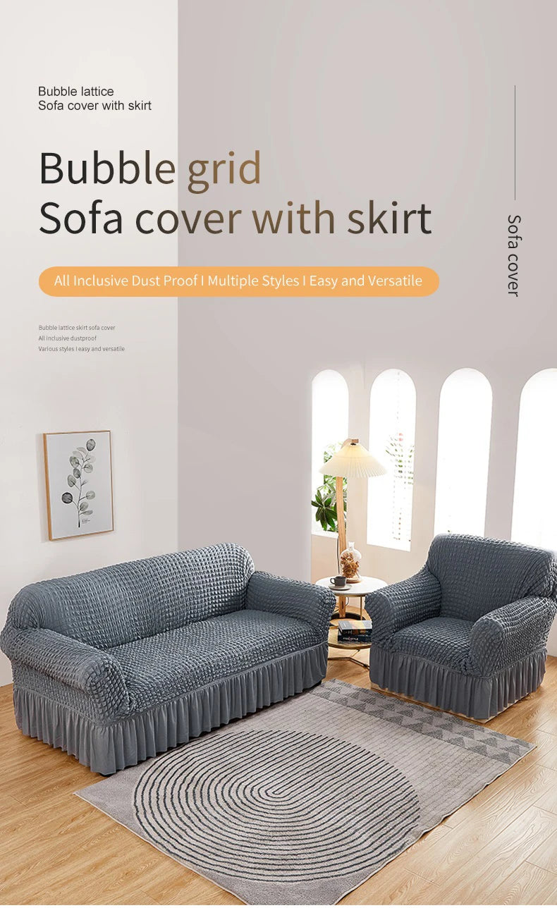 A gray stretch knit sofa cover with a skirt and bubble lattice texture displayed on a sofa.