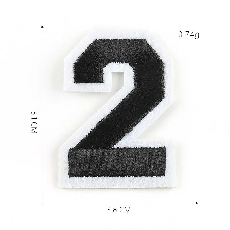 A black and white embroidered number 2 patch measuring 5.1 cm by 3.8 cm.