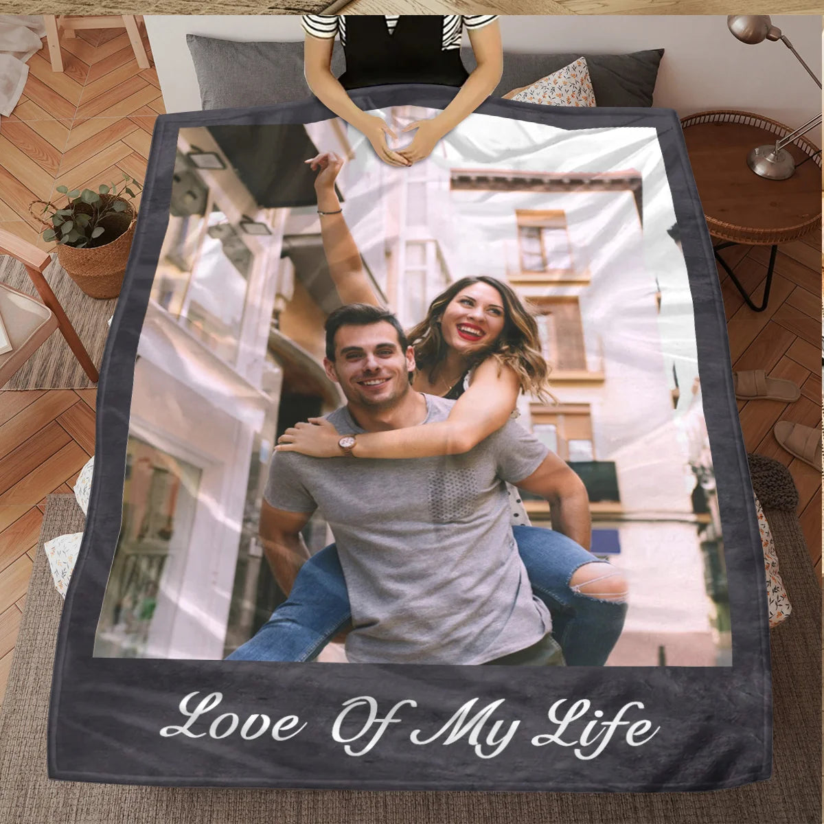 A personalized photo frame blanket featuring a couple smiling in an architectural setting.