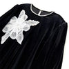 Black velvet fabric featuring a white floral sequin lace applique patch on the shoulder