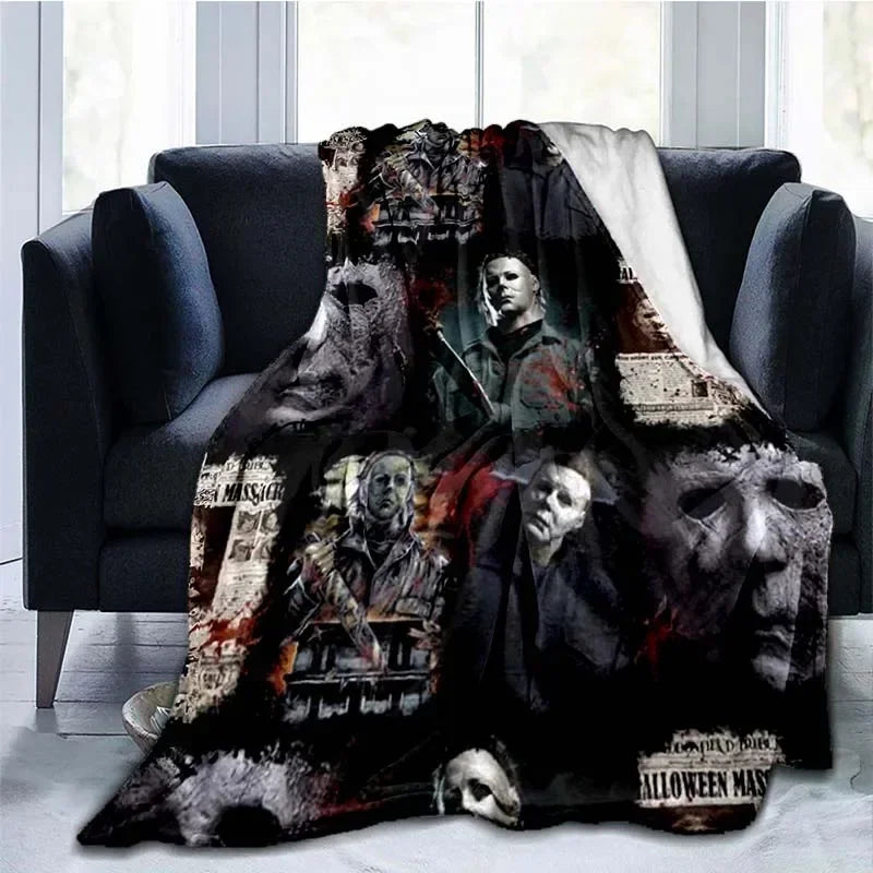 A dark horror themed throw blanket featuring images of Michael Myers and other masked figures.