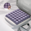 A purple adjustable press-to-inflate seat cushion with individual air cells shown in a close-up view.