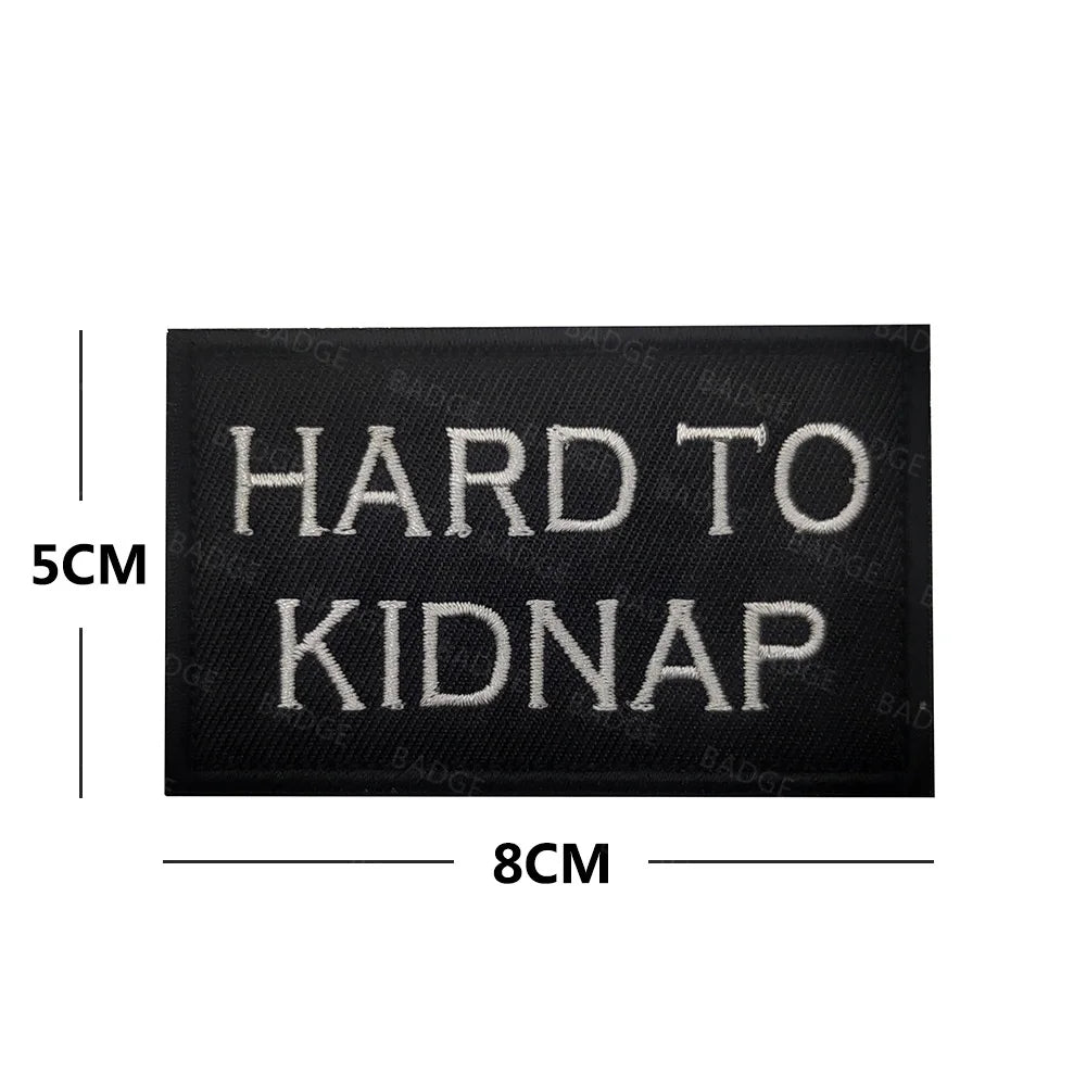 Black embroidered patch with white text that reads HARD TO KIDNAP