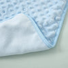Light blue and white fleece swaddle blanket with a quilted texture shown from the side.