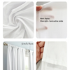 Close-up display of white fabric drapes showing light filtering and hand outline visibility.