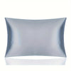 A smooth, light blue silky satin pillowcase lying flat against a white surface.