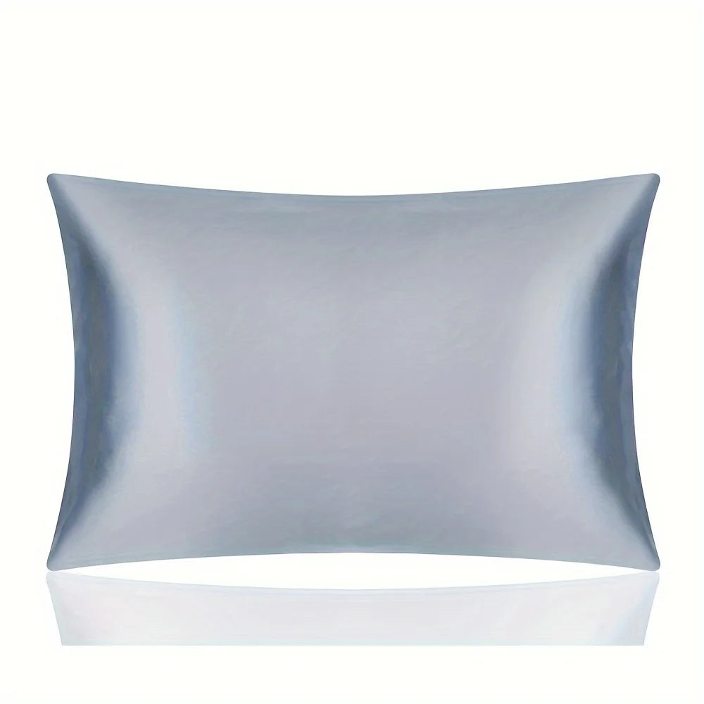 A smooth, light blue silky satin pillowcase lying flat against a white surface.